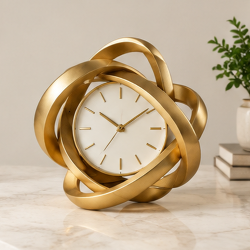 ESSENTIN Sculptural Knot Table Clock in gold on a marble surface — elegant modern home decor